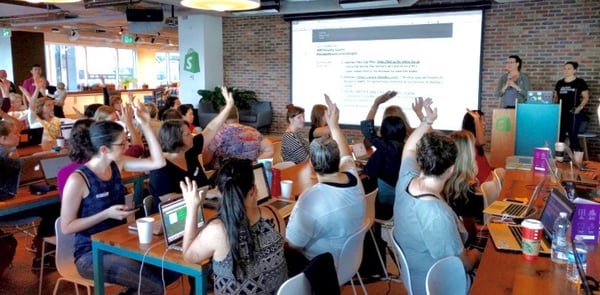 students raising hands on national learn to code day