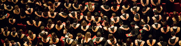 crowd of graduating students in black and red robe