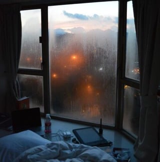 foggy window by a bedside on a rainy day