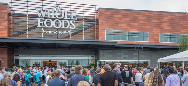 whole foods market building with a crowd in front