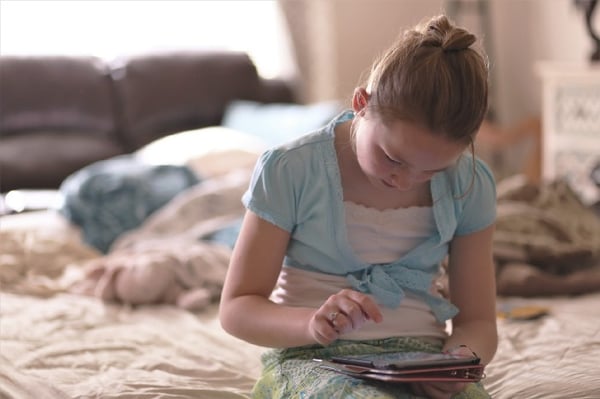 Girl watching show on an iPad