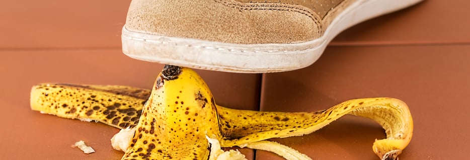 closeup of foot stepping on a banana peel 