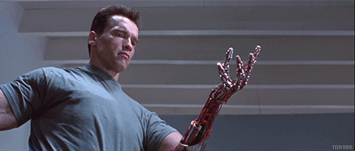 terminator arnold schwarzenegger squeezing mechanical hand in a fist