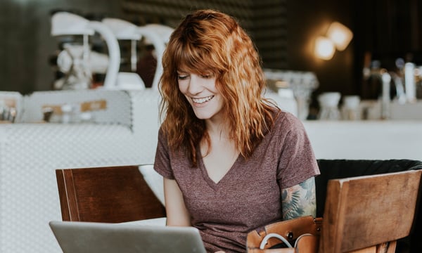 woman smiling to a computer