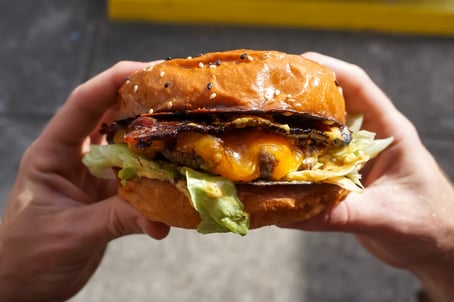 hands holding a burger