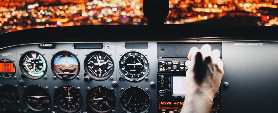 hand piloting a plane 