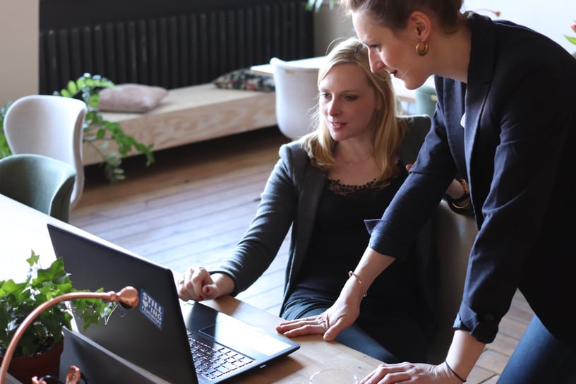 women working together on a computer