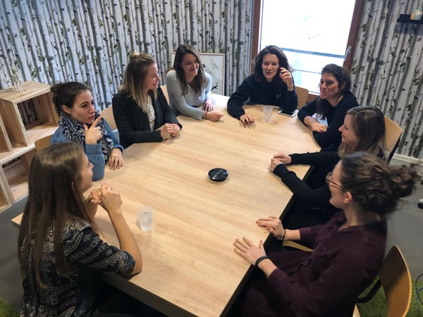 women of dataiku sitting around conference room table in paris office