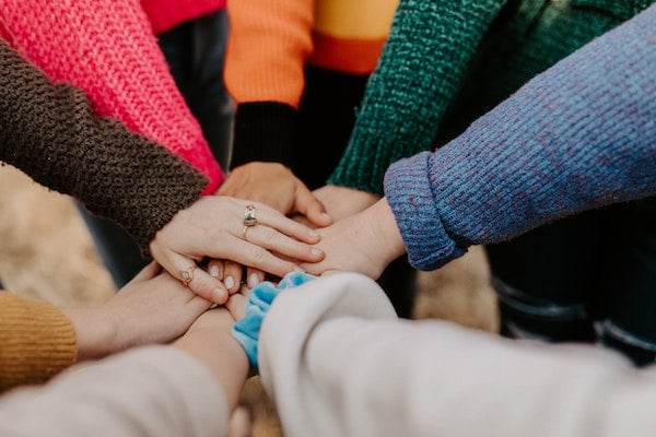 people's hands in a pile