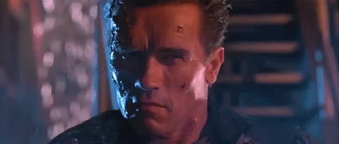 Arnold Schwarzenegger in Terminator pointing a gun and saying hasta la vista