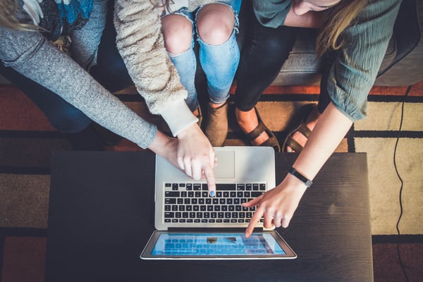 data science community, people looking at a screen together 