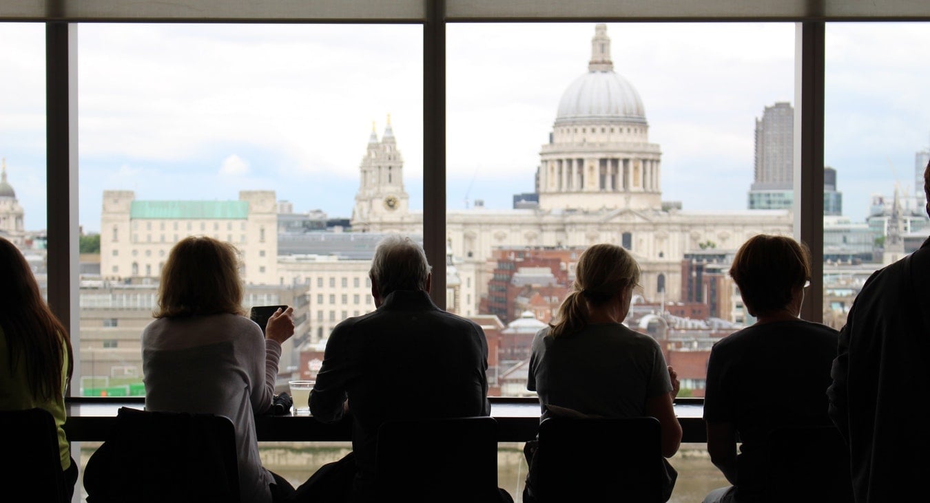 people in London looking out a window