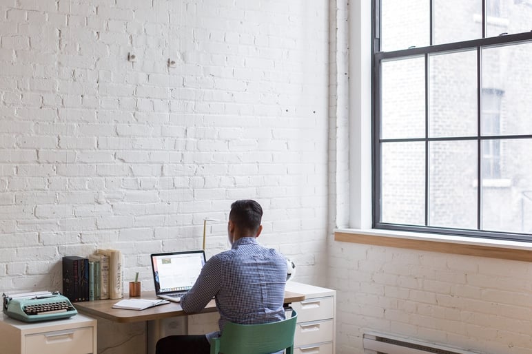 man working from home on a laptop