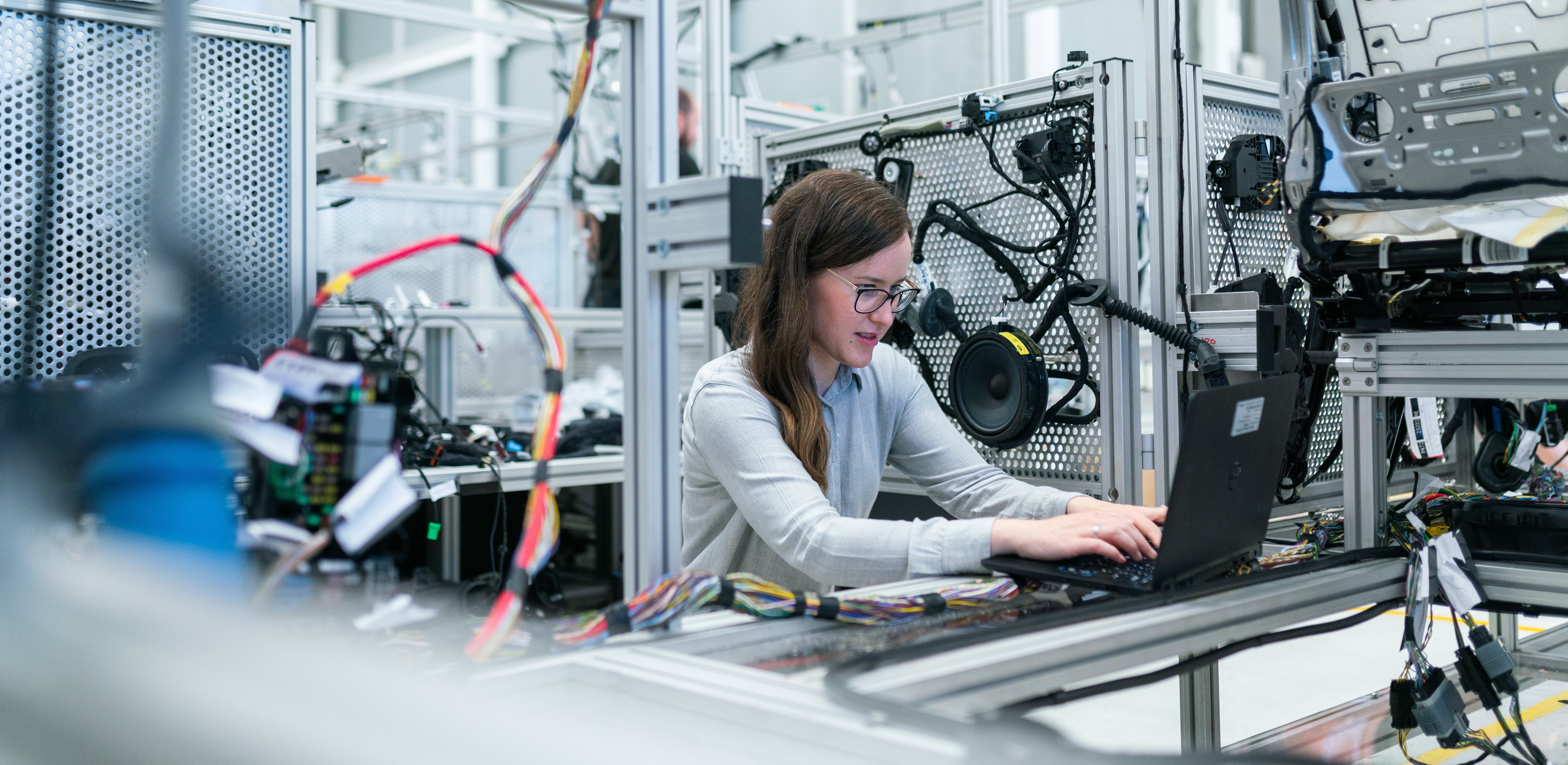 woman working on a laptop in an engineering manufacturing environment