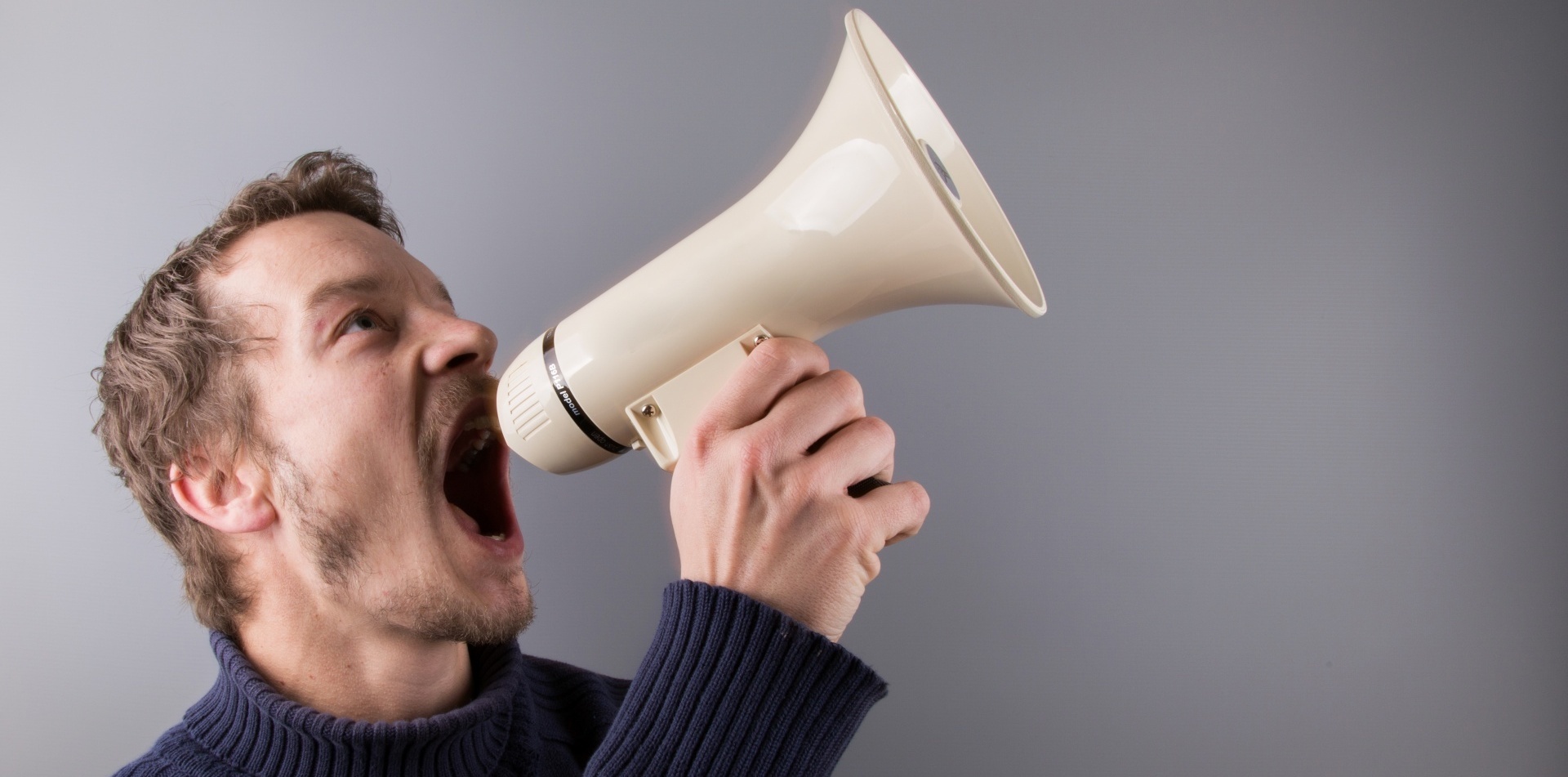 man screaming in megaphone