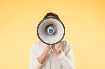 girl with megaphone on a yellow background