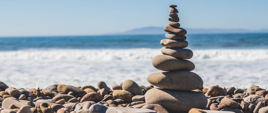 a pile of rocks in front of the ocean