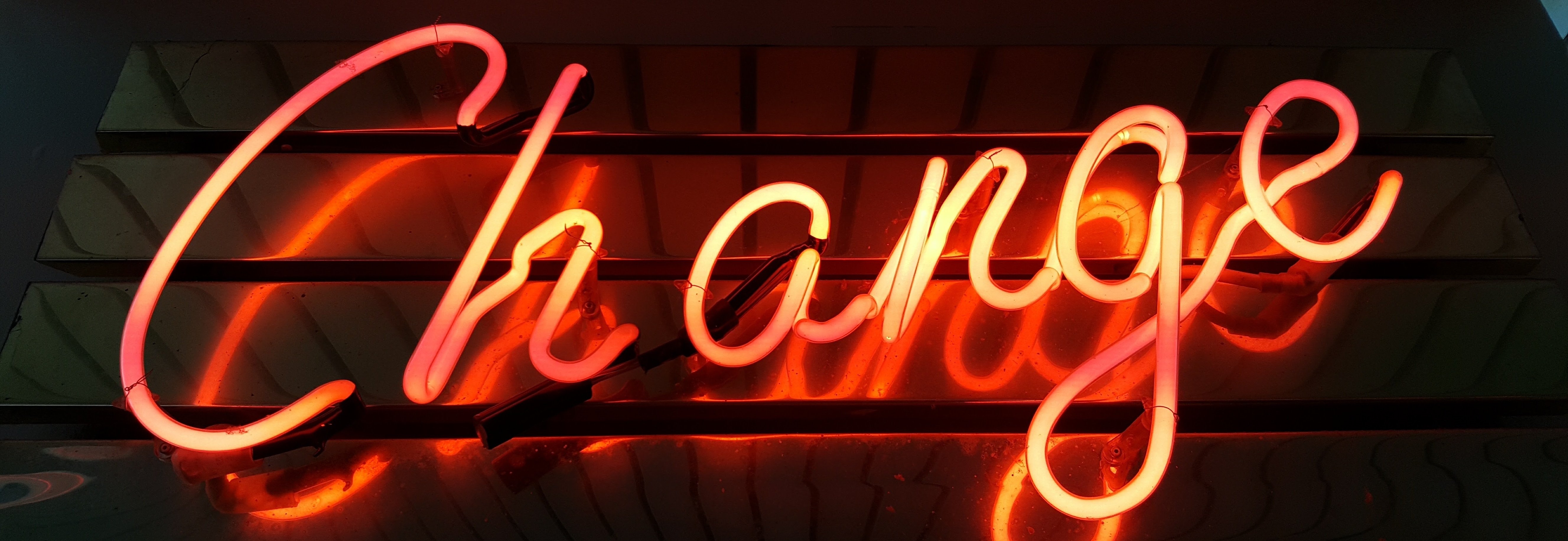 neon sign with the word change