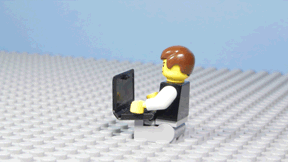 lego man working on a computer frustrated