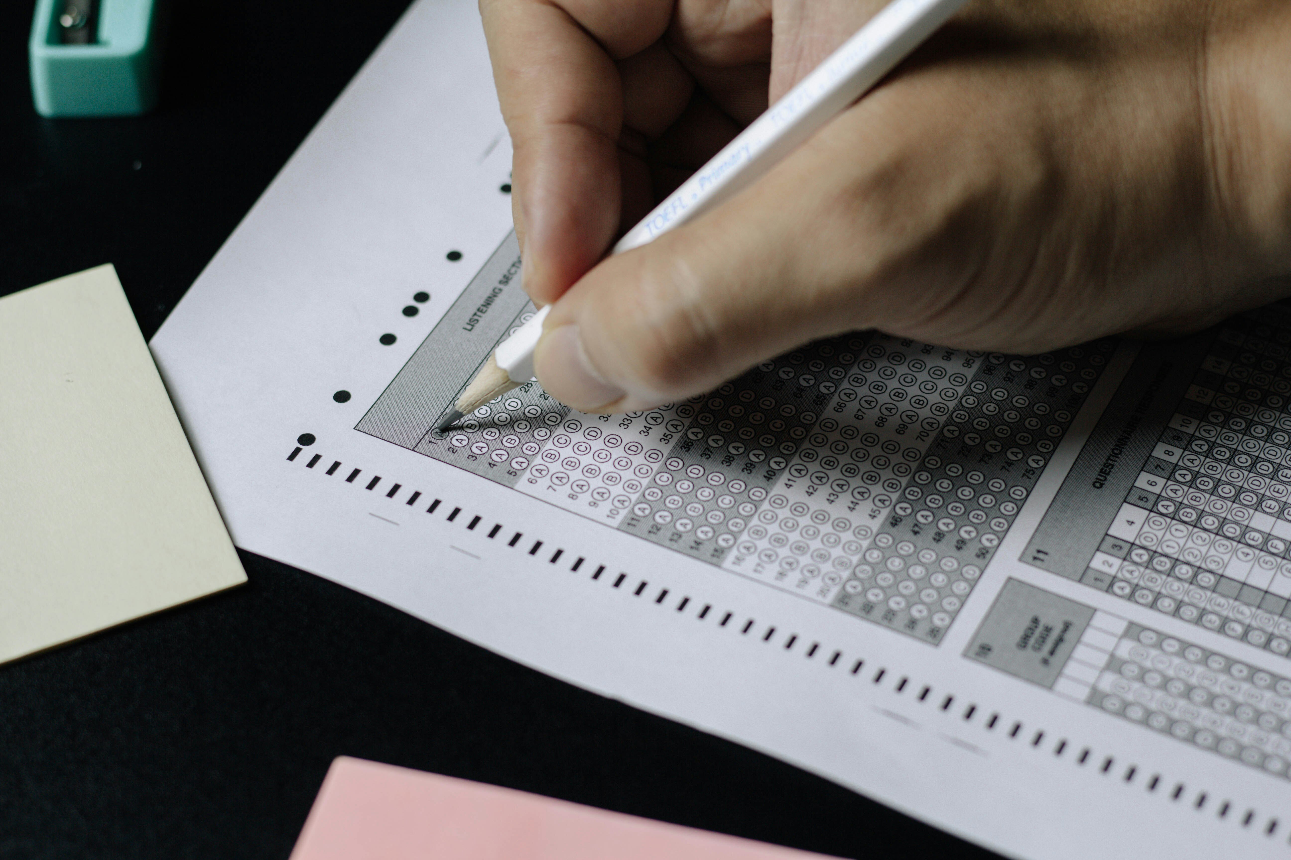 hand completing a paper test